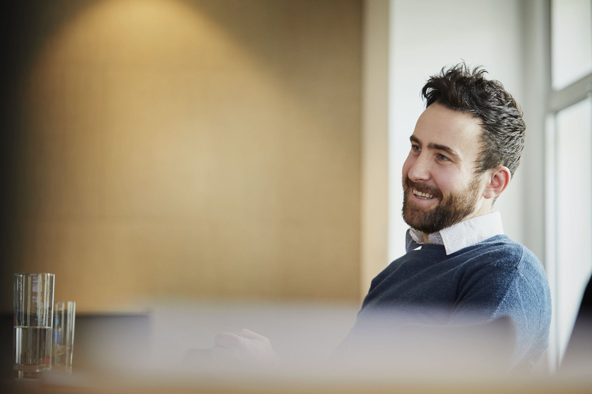 businessman-in-office-looking-away-smiling-2026-03-25-07-17-49-utc (1)