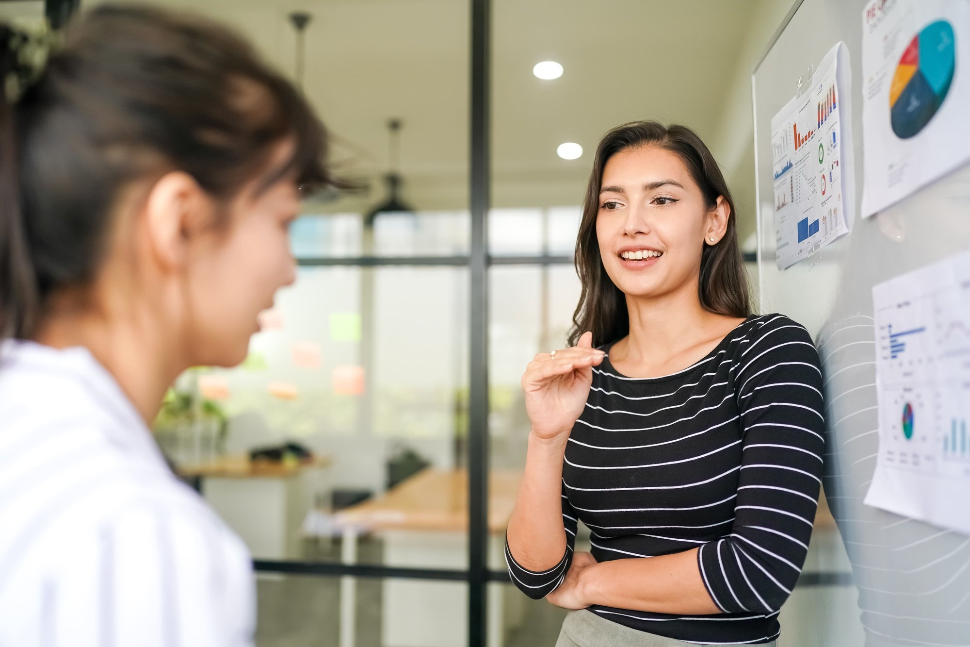 businesswoman-pointing-at-charts-on-whiteboard-dur-2026-01-07-07-26-04-utc (1)